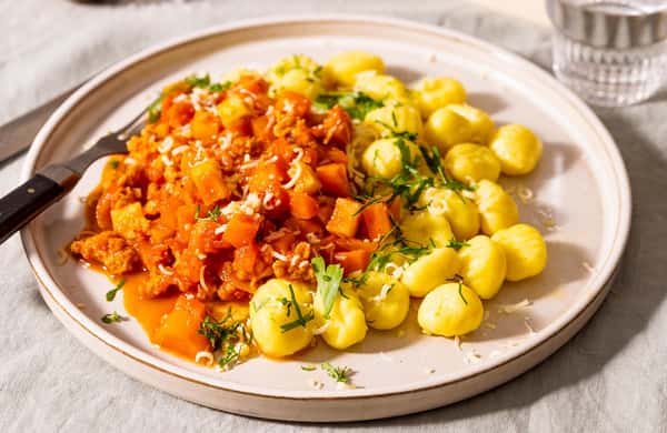 Tomatisert kyllingragu med rotgrønnsaker, gnocchi og revet Grande Premium